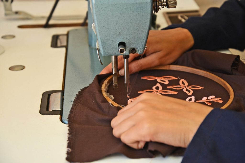 Broderie en cours sur un vêtement, cerceau et machine