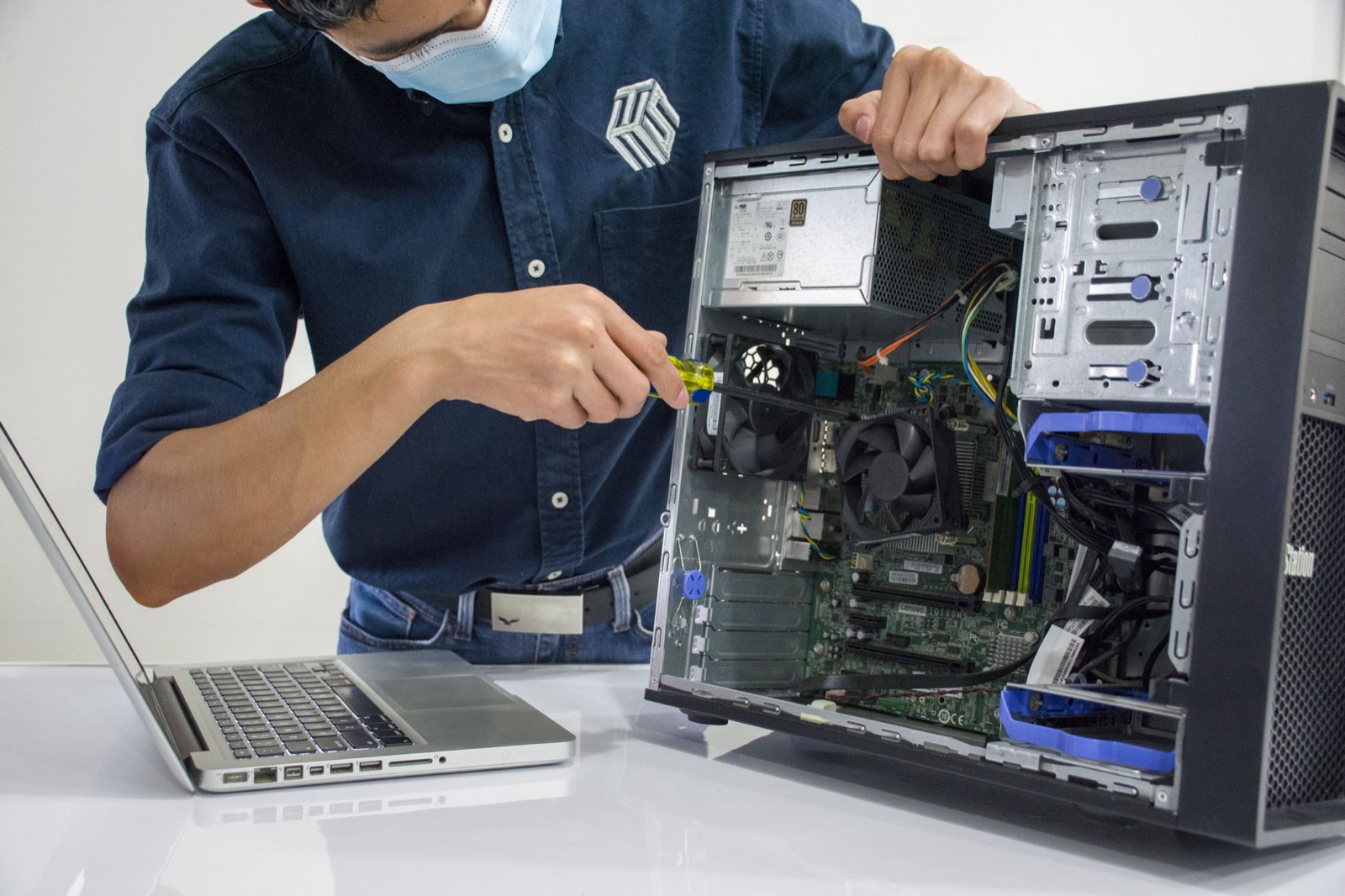 Technicien réparant un ordinateur de bureau en atelier